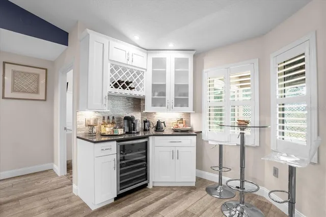a kitchen with granite countertop a sink and cabinets