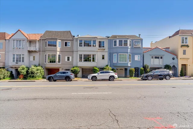 a living room with furniture and a dining table with wooden floor