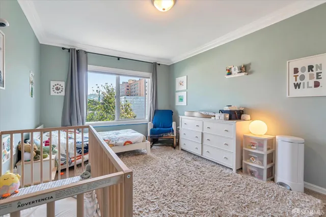 a view of empty room with wooden floor and fireplace