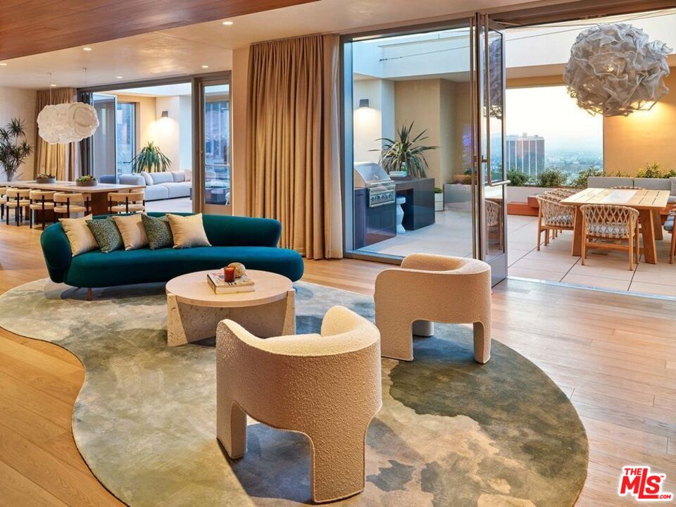 151 South Olive Street, Unit PH4501 Los Angeles, CA 90012 - Photo 11 of 14 a living room with furniture and a large window