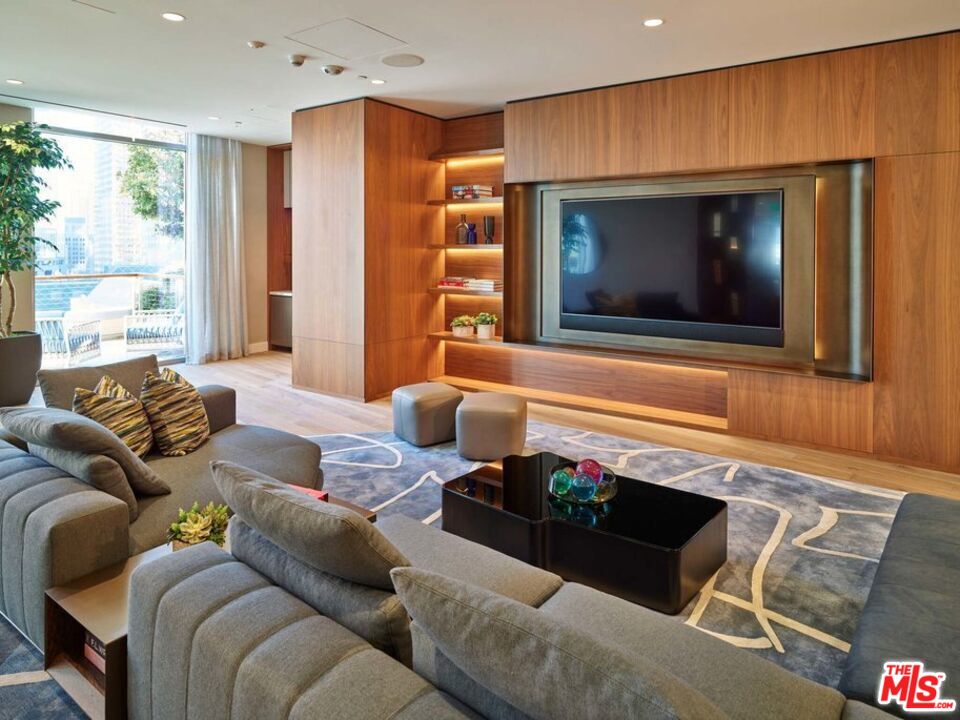 151 South Olive Street, Unit PH4501 Los Angeles, CA 90012 - Photo 7 of 14 a living room with furniture and a flat screen tv