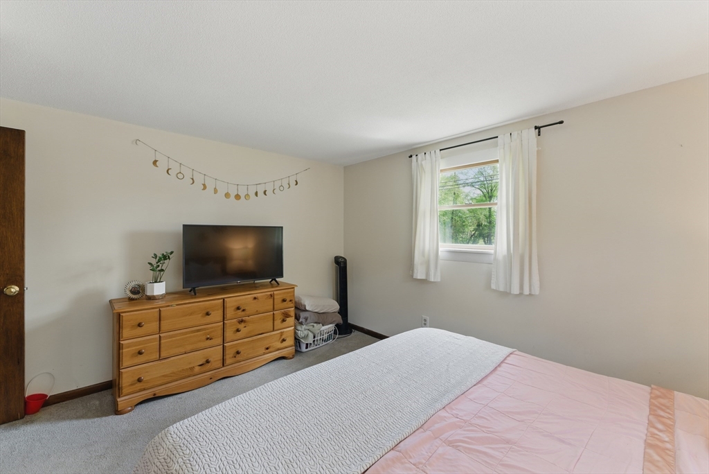 19 Straits Road Hatfield, MA 01038 - Photo 28 of 42 a bedroom with furniture and flat screen tv