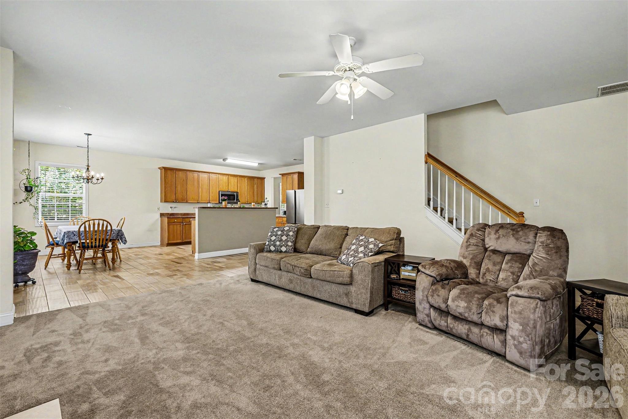 3035 Proverbs Court Monroe, NC 28110 - Photo 14 of 30 a living room with furniture and a dining table with kitchen view