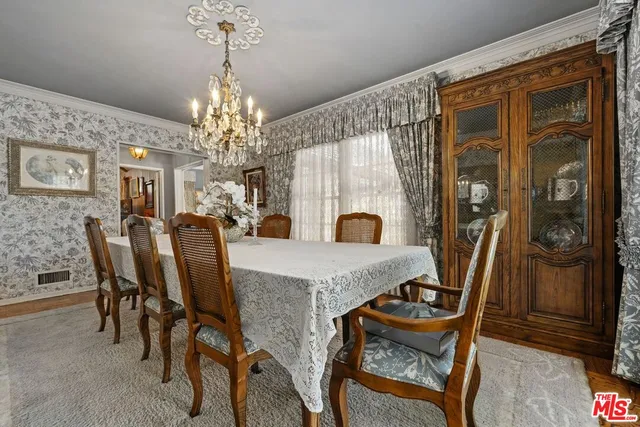 a view of a dining room with furniture and chandelier