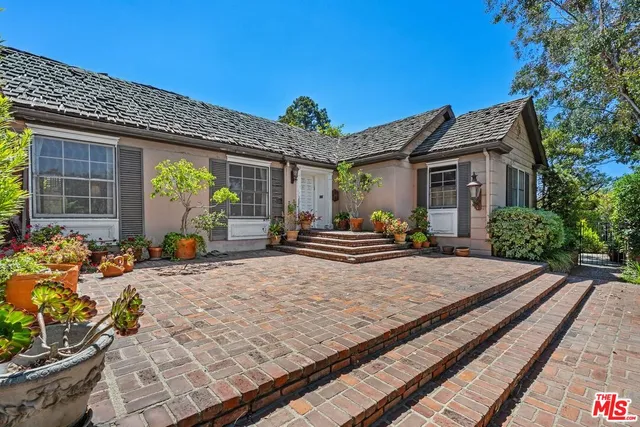 a view of a house with chairs in the patio