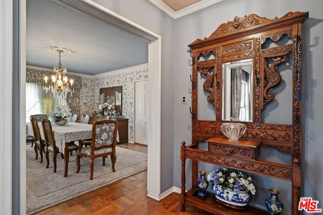 a view of a dining room with furniture and chandelier