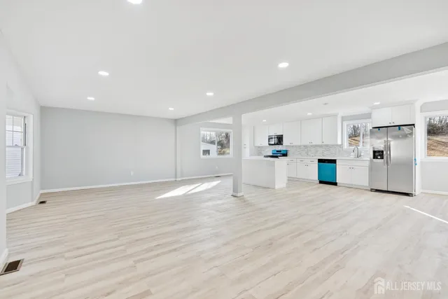 a view of a big room with kitchen view and a window