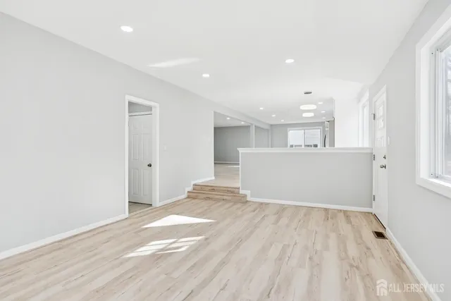 a view of wooden floor and windows in a room