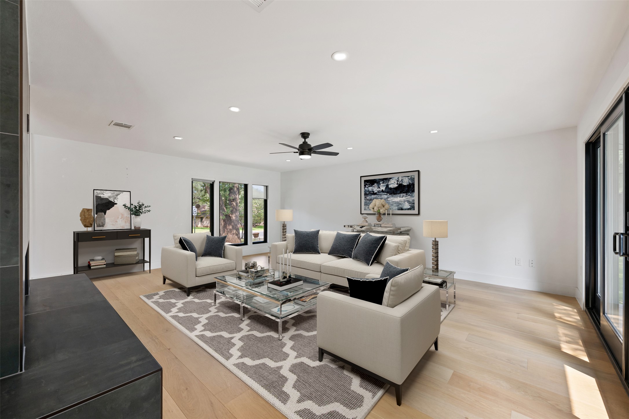 8900 Point W Drive Austin, TX 78759 - Photo 6 of 40 A spacious, naturally illuminated living room showcasing light-toned hardwood flooring.
