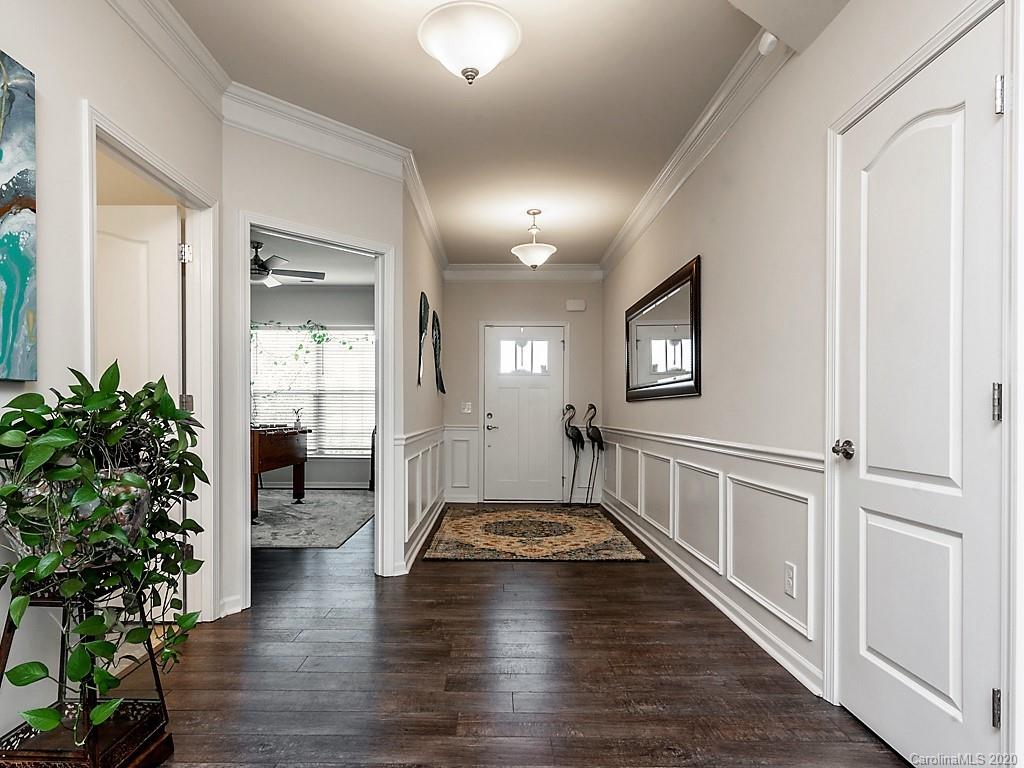 7004 Fallondale Road Waxhaw, NC 28173 - Photo 5 of 37 a view of a hallway with wooden floor and a potted plant