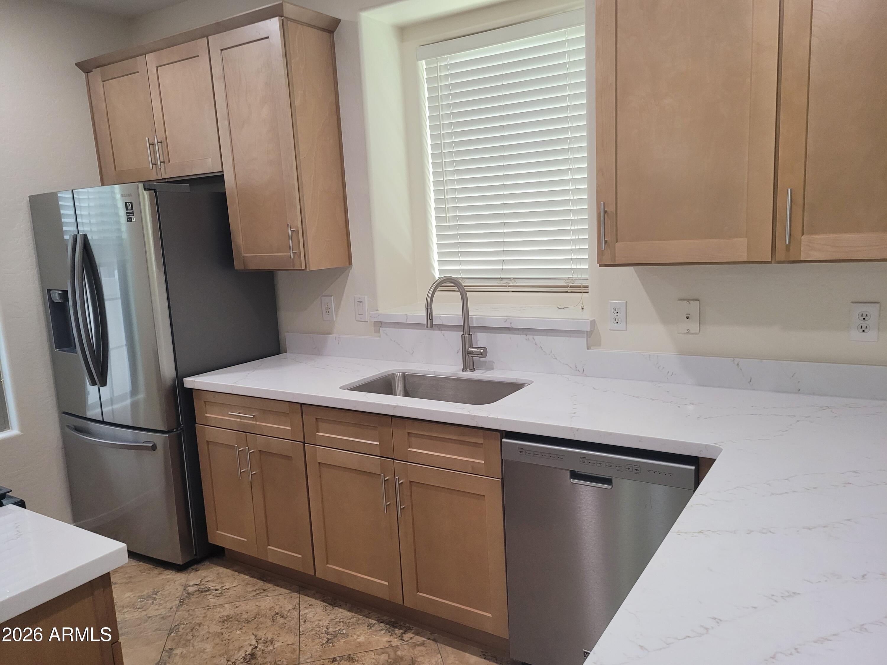 1453 South Sinova Avenue Gilbert, AZ 85296 - Photo 17 of 46 a kitchen with stainless steel appliances granite countertop a sink a refrigerator and a cabinets