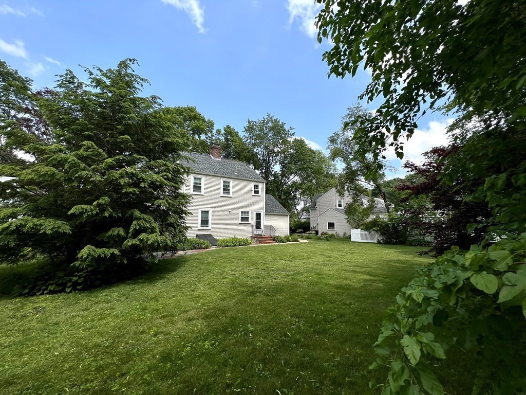 28 Farmington Road Newton, MA 02465 - Photo 3 of 6 a front view of a house with a garden and trees