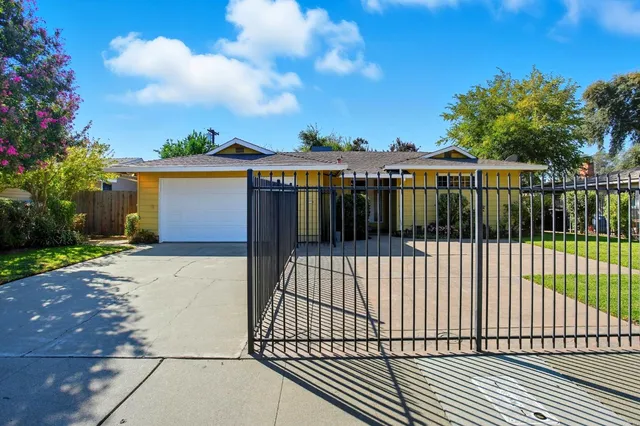 a view of a house with a wooden fence