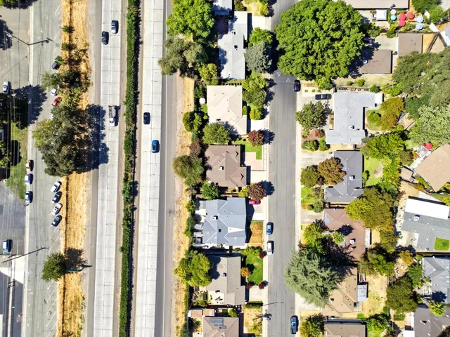 an aerial view of a house with a yard