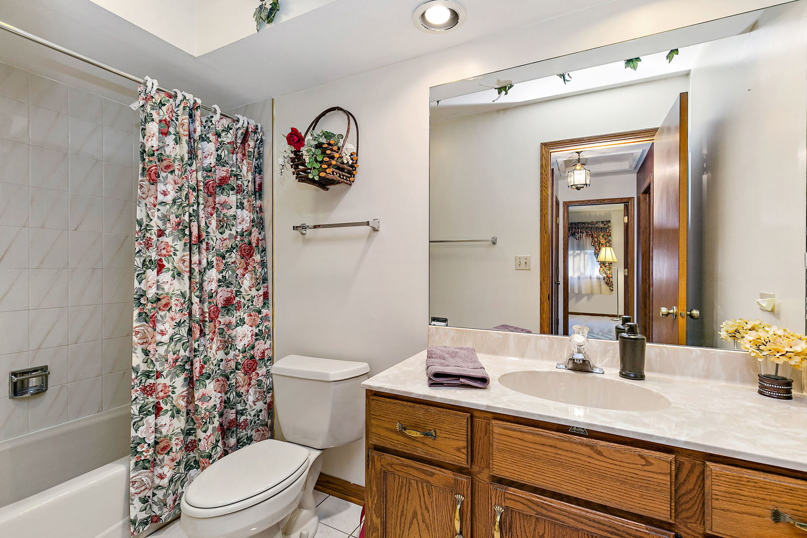 775 Stephen Drive Palatine, IL 60067 - Photo 16 of 19 a bathroom with a sink a toilet a shower curtain and a large mirror