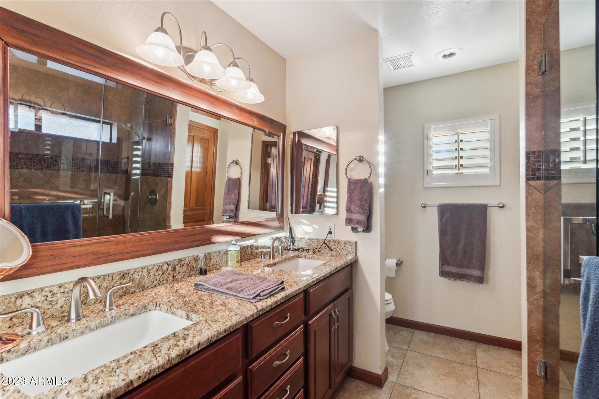 31 West Royal Palm Road Phoenix, AZ 85021 - Photo 13 of 24 a bathroom with a granite countertop sink and a mirror
