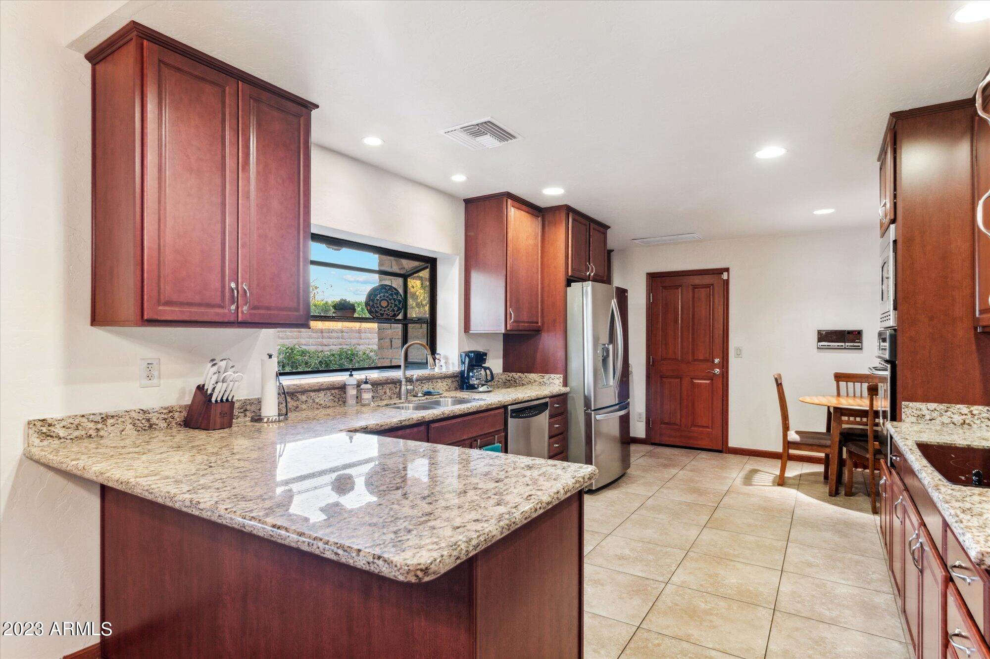 31 West Royal Palm Road Phoenix, AZ 85021 - Photo 8 of 24 a kitchen with stainless steel appliances granite countertop a sink stove and refrigerator