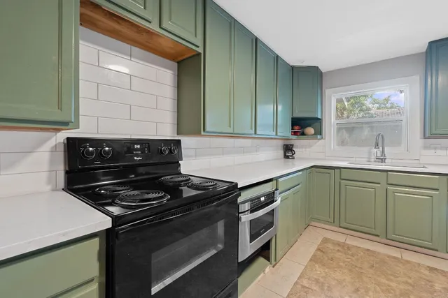 a kitchen with a stove and a sink