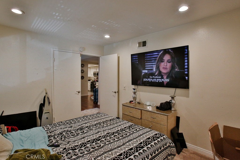 6637 Caro Street Paramount, CA 90723 - Photo 13 of 61 a bedroom with a bed and a flat screen tv