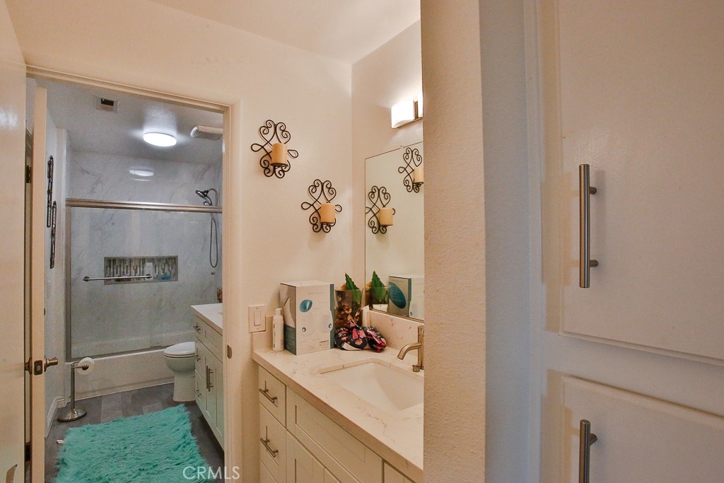 6637 Caro Street Paramount, CA 90723 - Photo 44 of 61 a bathroom with a sink mirror vanity and toilet