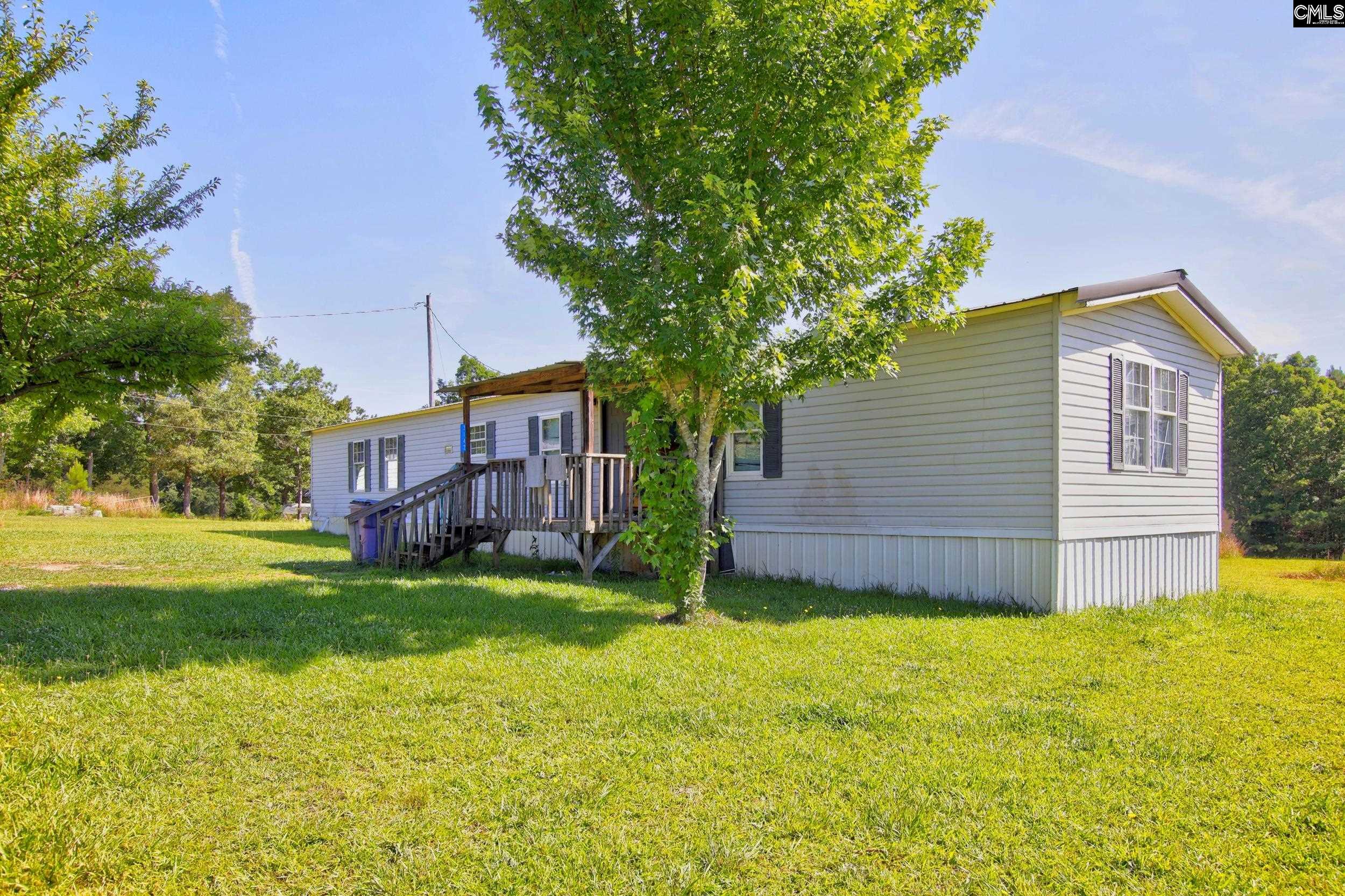 3140 Highway 702 Chappells, SC 29037 - Photo 15 of 39 a view of a house with a yard and a tree