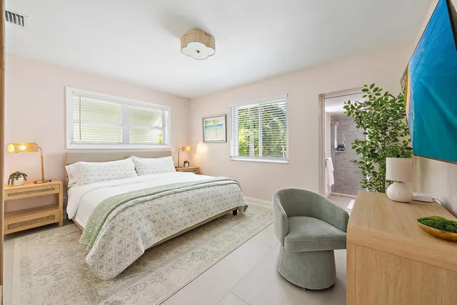 a bedroom with bed couch and window