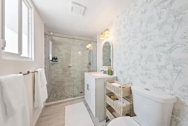 a bathroom with a sink toilet and shower