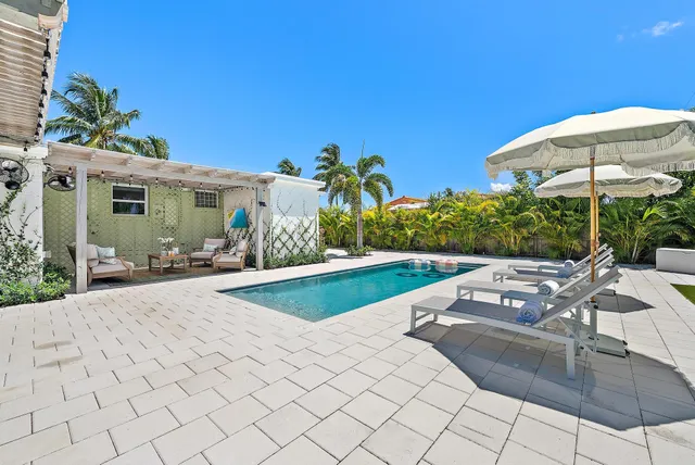 swimming pool view with a seating space