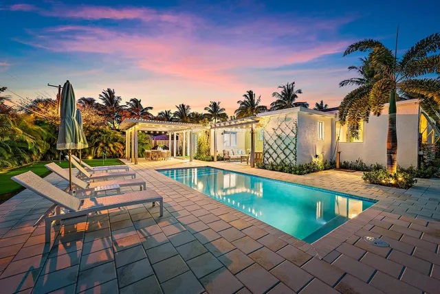 a view of a swimming pool with a lounge chairs