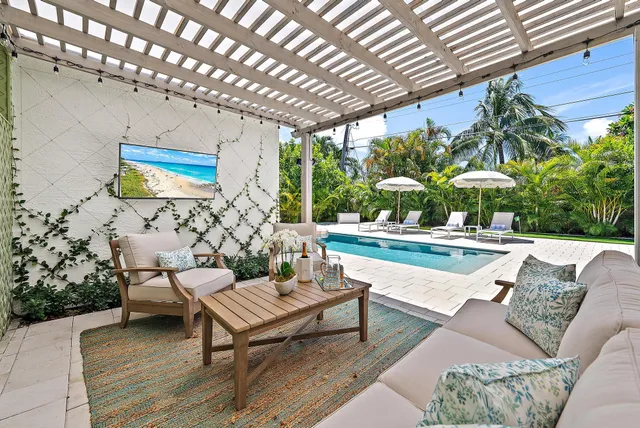 a view of a patio with couches and table with garden view