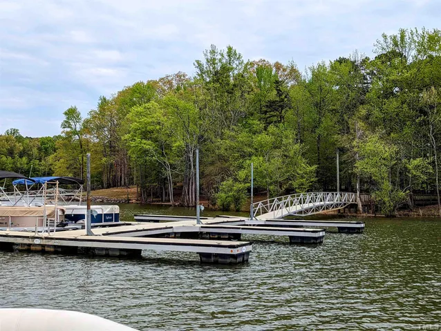 a backyard of a house with fire pit and outdoor seating