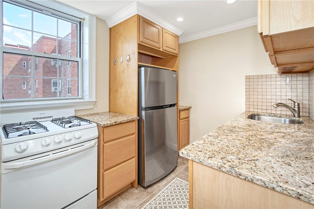 210 Pelham Road, Unit 5C New Rochelle, NY 10805 - Photo 1 of 1 a kitchen with stainless steel appliances granite countertop cabinets and a refrigerator