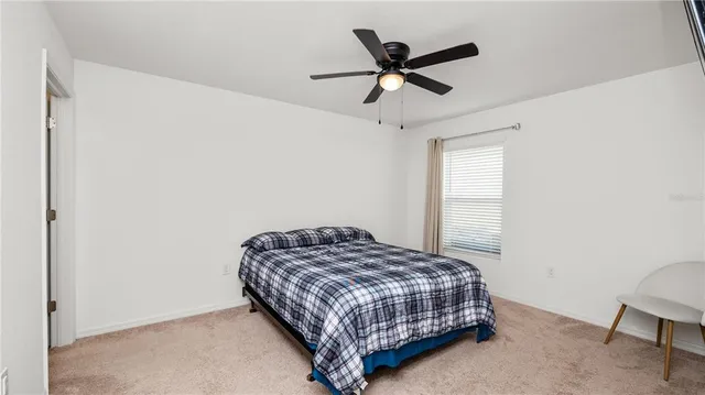 a bedroom with a bed a window