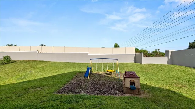 a view of a backyard with furniture