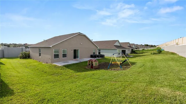 a view of a house with a yard and sitting area