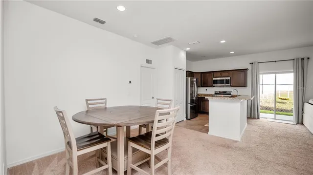 a view of a dining room with furniture and window