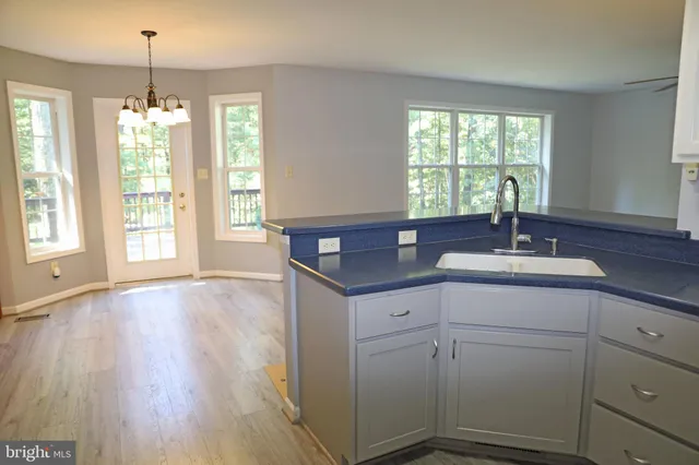 a view of an entryway with wooden floor and a cabinet