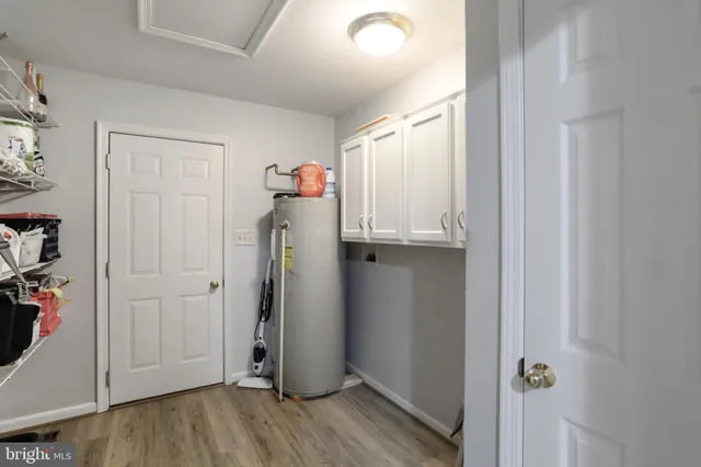 a view of a backyard with table and chairs with wooden fence and trees