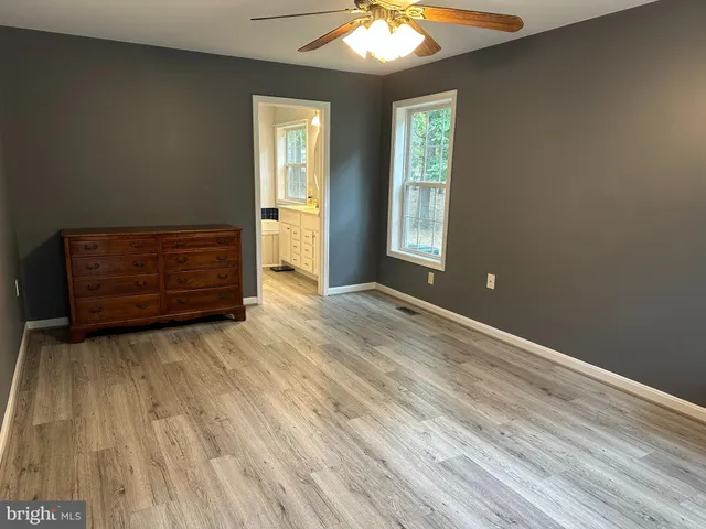 a view of a house with a yard and large tree