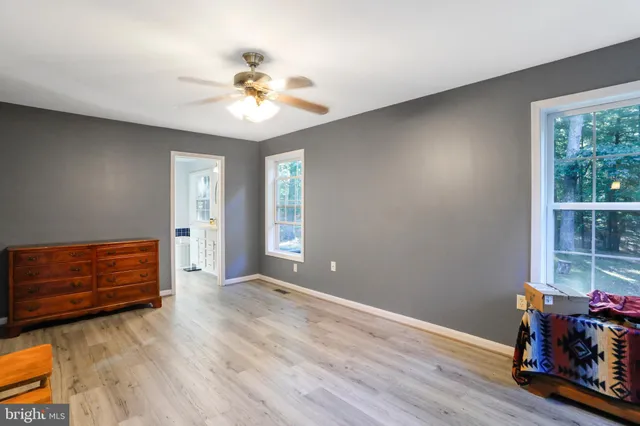 an aerial view of residential house with outdoor space and trees all around