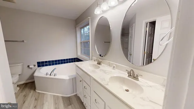 a view of a lush green forest with trees and some houses