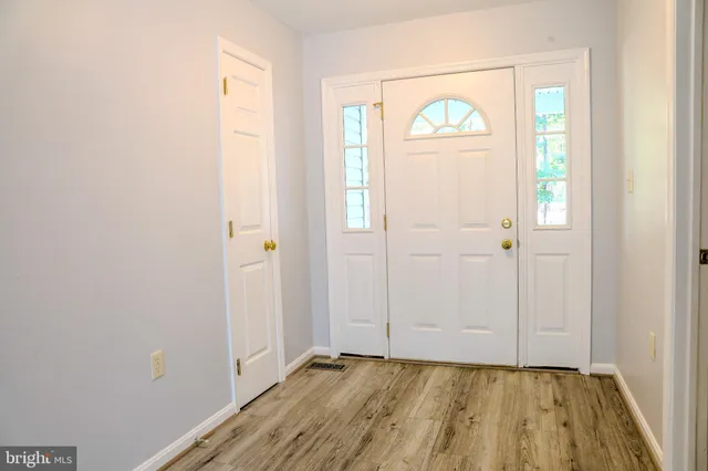 a kitchen with stainless steel appliances granite countertop a sink stove and wooden floor