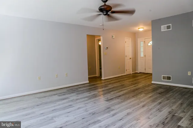 a kitchen with stainless steel appliances granite countertop a stove and a wooden floors