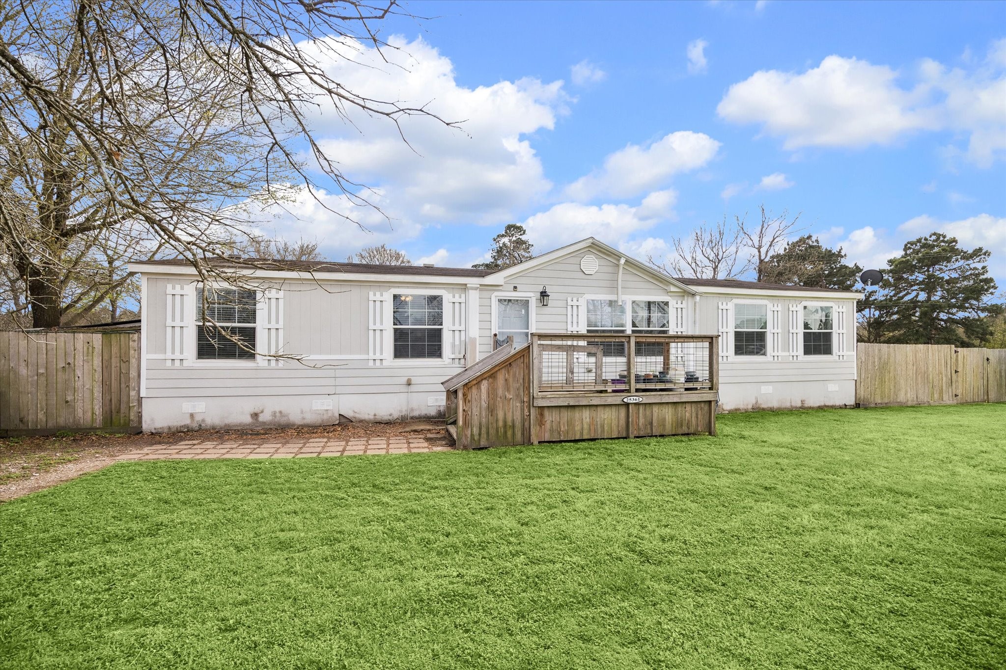 a view of a house with a yard and sitting area