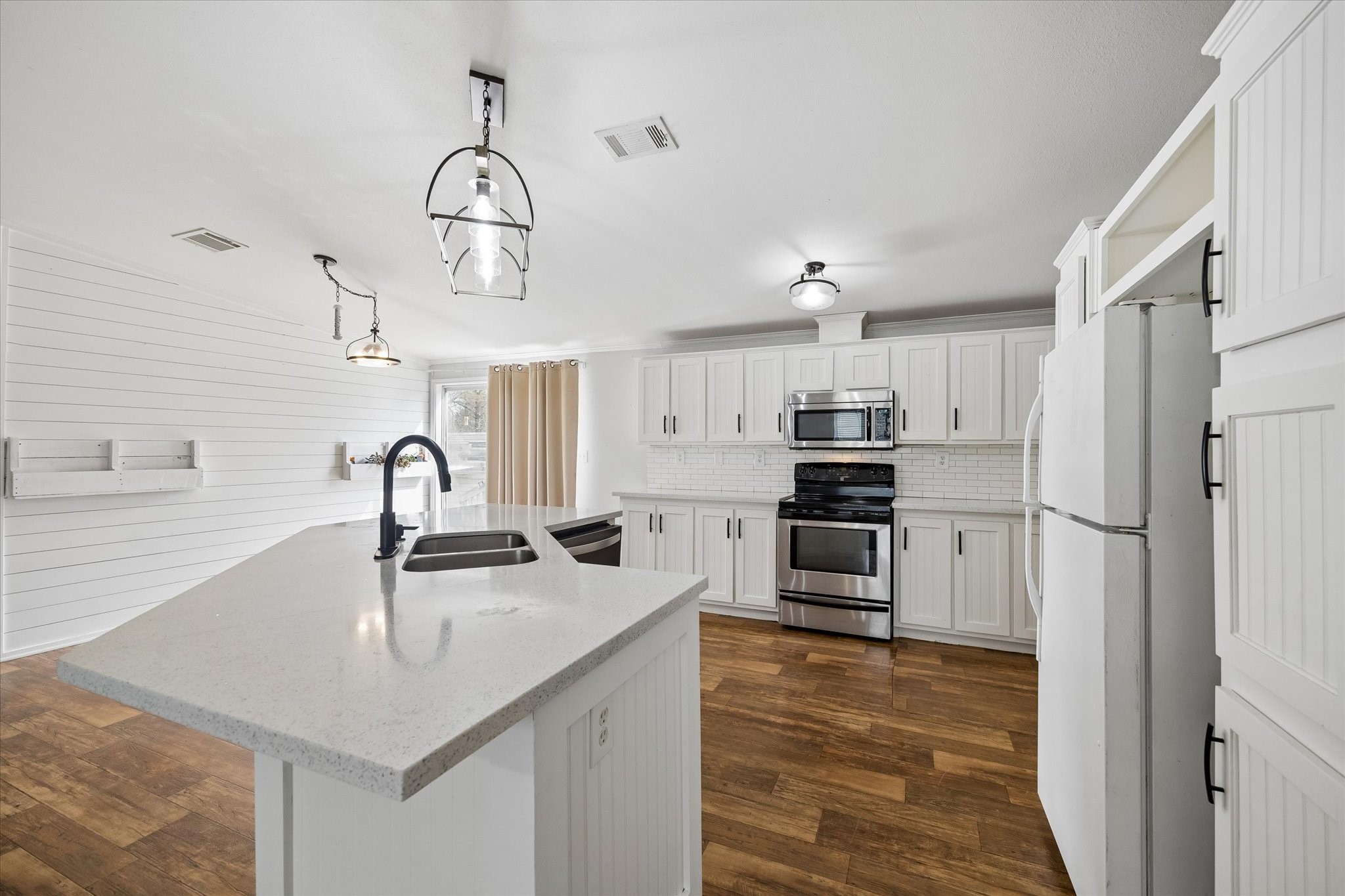 25361 Bluff View Court Magnolia, TX 77355 - Photo 3 of 10 a kitchen with stainless steel appliances granite countertop a sink and a refrigerator
