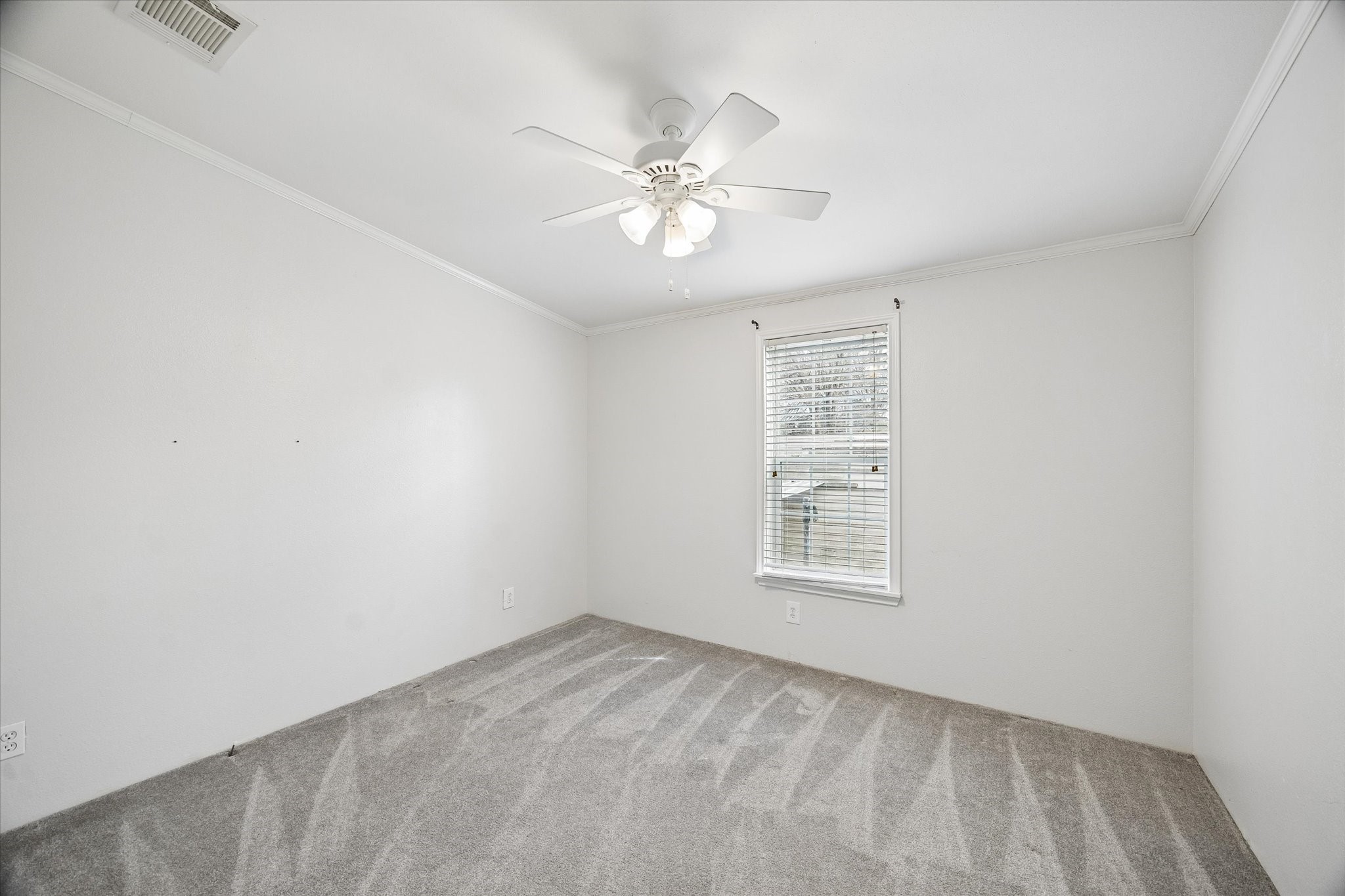 25361 Bluff View Court Magnolia, TX 77355 - Photo 7 of 10 an empty room with a window and a fan