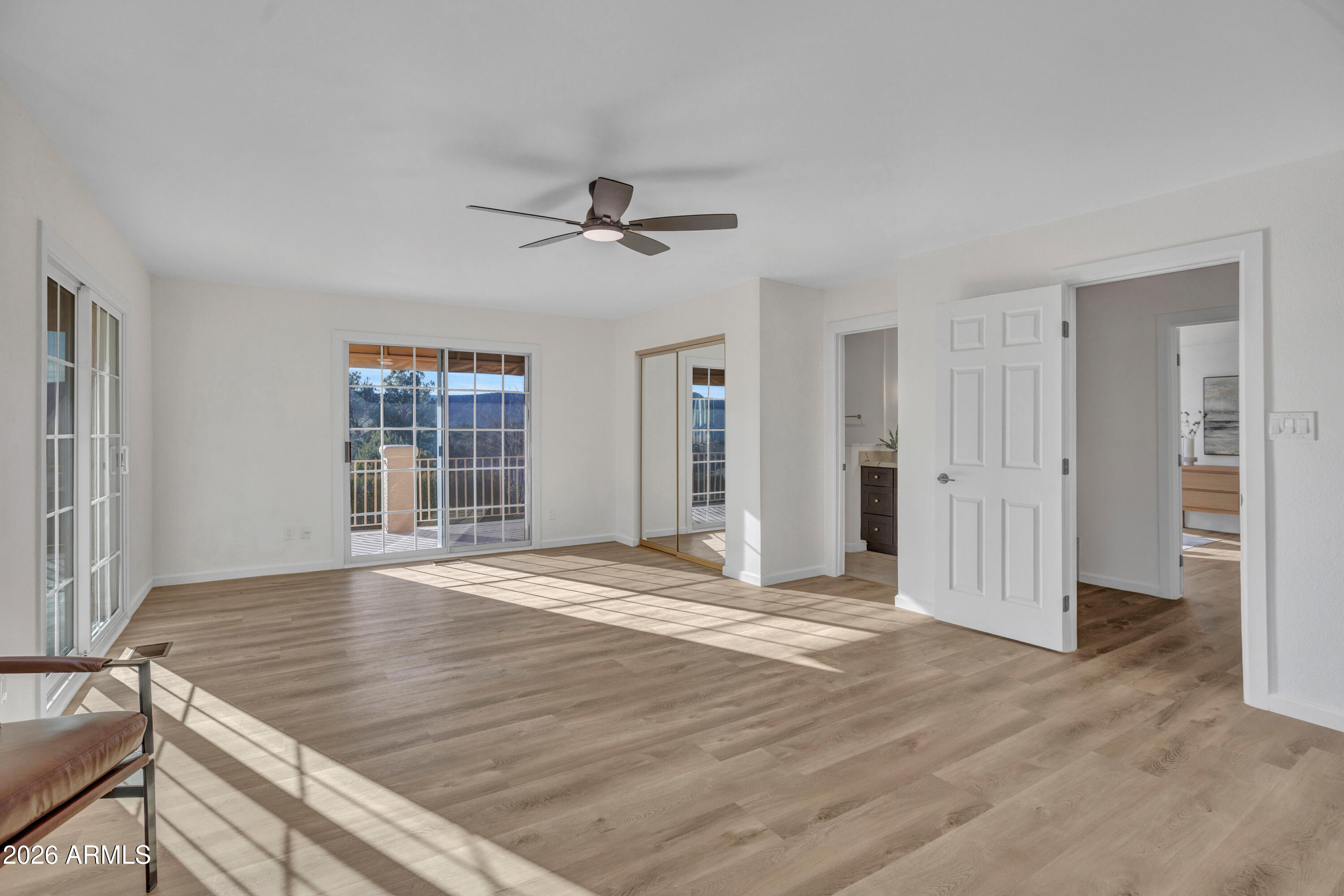 115 Stone Way Sedona, AZ 86351 - Photo 35 of 61 a view of an empty room with wooden floor and a window