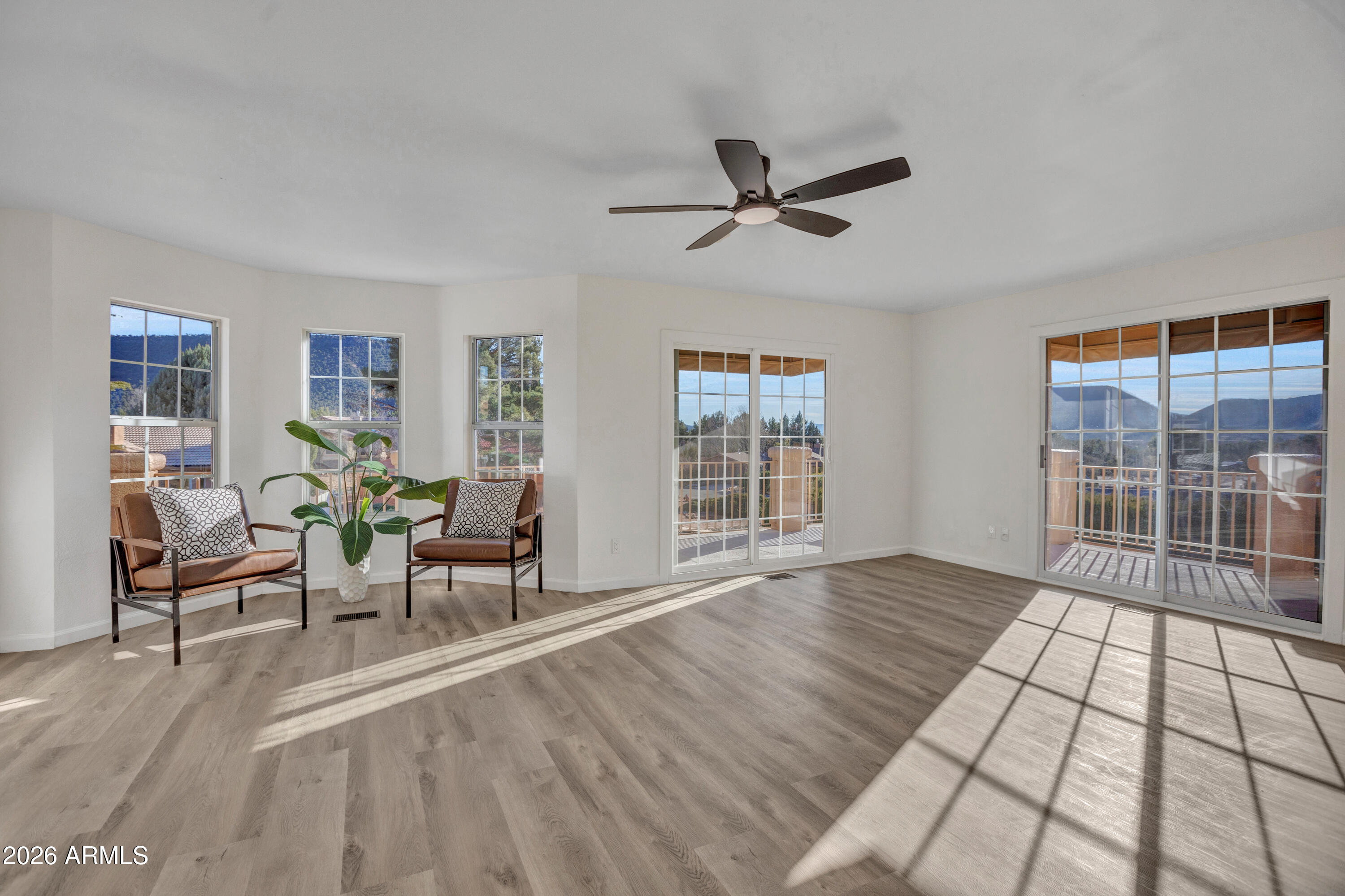 115 Stone Way Sedona, AZ 86351 - Photo 36 of 61 a living room with furniture floor to ceiling window and wooden floor
