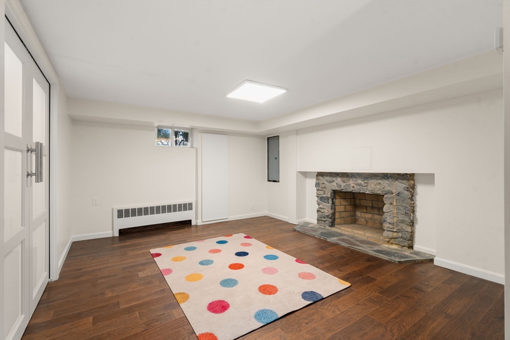 50 Mary Ellen Road Newton, MA 02468 - Photo 13 of 22 a view of an empty room with a fireplace and a window