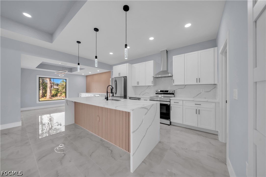 4028 26th Street Southwest Lehigh Acres, FL 33976 - Photo 12 of 38 a kitchen with white cabinets and white appliances